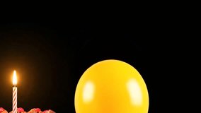 Bright yellow balloon floating with confetti and a lit birthday candle on a black background, celebrating a special occasion with festive decorations - Powered by Shutterstock - Get 15% off with code: PIKWIZARD15