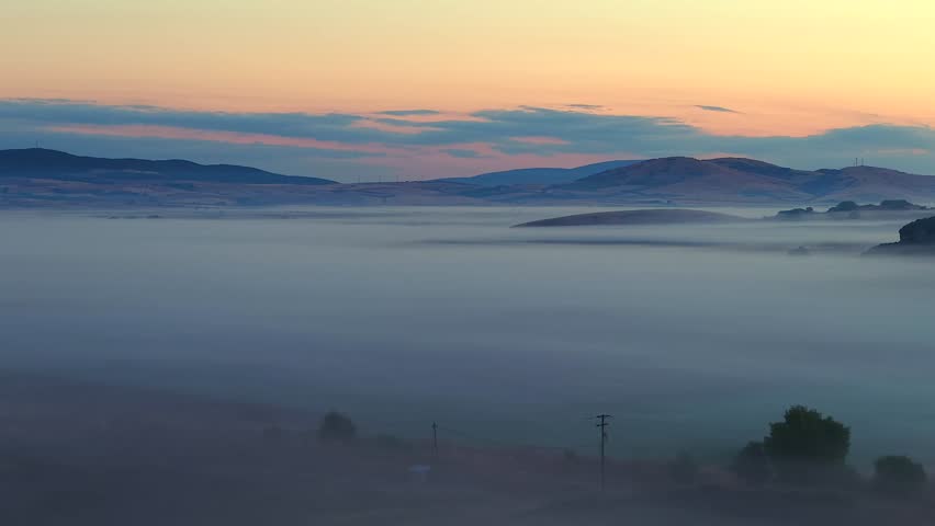 Golden Hour Aerial Flyover of Foggy Fields at Sunrise in Serene Light