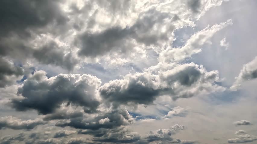 Flowing rainy clouds in the blue skies. 4K video (Ultra High Definition) of cloudscape. Dramatic sky and clouds Timelapse. 