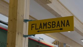 Interior shot from Flåm Railway Museum, Norway, featuring FLÅMSBANA directional signage and vintage train car in a timber-framed station setting. - Powered by Shutterstock - Get 15% off with code: PIKWIZARD15