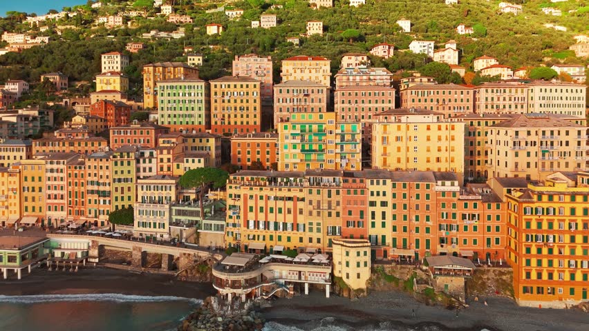 Aerial view of the picturesque historic town of Camogliat sunset in Liguria, Italy. Historic Castello della Dragonara and Basilica di Santa Maria Assunta with colorful buildings above Ligurian Sea
