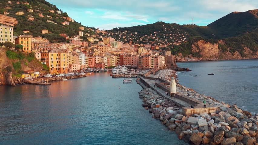 Aerial view of the picturesque historic town of Camogliat sunset in Liguria, Italy. Historic Castello della Dragonara and Basilica di Santa Maria Assunta with colorful buildings above Ligurian Sea