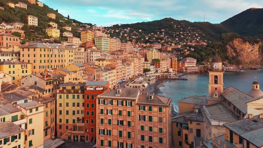Aerial view of the picturesque historic town of Camogliat sunset in Liguria, Italy. Historic Castello della Dragonara and Basilica di Santa Maria Assunta with colorful buildings above Ligurian Sea