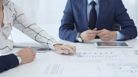 Corporate team reviewing financial data, collaborating around digital tablet and paperwork, analyzing market trends in modern office setting with professional demeanor - Powered by Shutterstock - Get 15% off with code: PIKWIZARD15