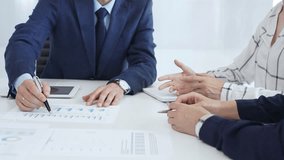 Corporate team reviewing financial data, collaborating around digital tablet and paperwork, analyzing market trends in modern office setting with professional demeanor - Powered by Shutterstock - Get 15% off with code: PIKWIZARD15