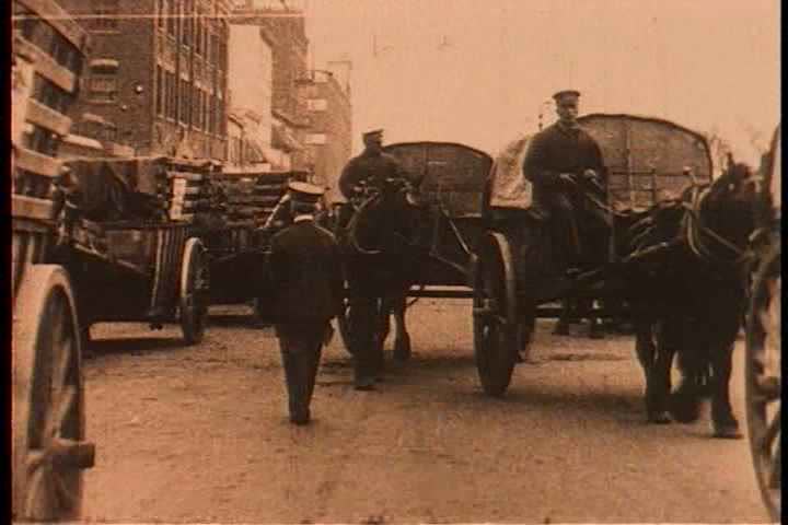 1920s - A crowded street in 1910 and a man teaches black street sweepers how to sweep.