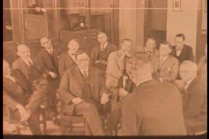 1920s - Businessmen and bankers gather to hear about a financial crisis effecting Wall St.