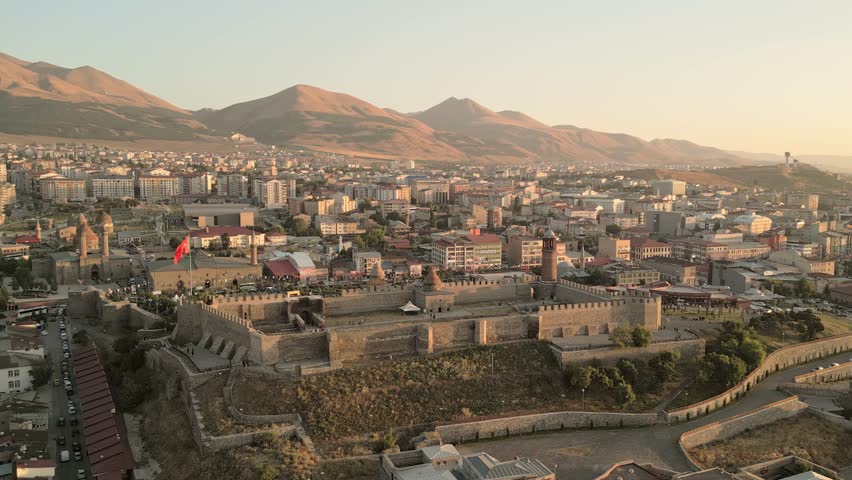Erzurum, Turkey - 20th august, 2025: Aerial Erzurum Castle and citadel, stone ramparts and clock-tower minaret above city golden hour; Byzantine 5th–6th c.origins with Seljuk - Ottoman restorations
