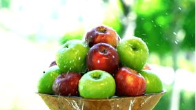 Slow Motion of Water Splashing Over a Pyramid of Fresh Red and Green Apples in a Bowl - Powered by Shutterstock - Get 15% off with code: PIKWIZARD15
