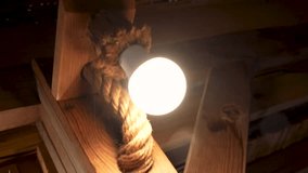 Vintage Edison Bulb Hanging with Rope on Wooden Background, Warm Light and Rustic Interior Decor - Powered by Shutterstock - Get 15% off with code: PIKWIZARD15