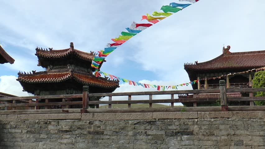 The territory of the Amarbayasgalant Mongolian Buddhist monastery and ritual objects on an autumn cloudy day.
