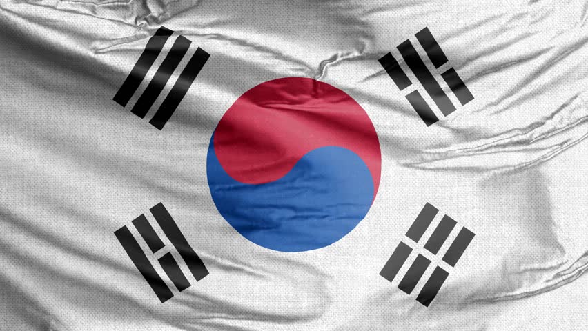 Close-up of the South Korean flag (Taegeukgi), showcasing its central red and blue Taegeuk symbol and four black trigrams, rippling gently.