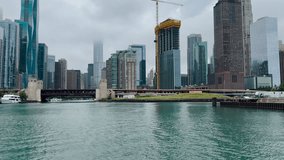 Majestic views of iconic Chicago, Illinois urban architecture and Lake Shore Drive as viewed from the Chicago River and Lake Michigan. A crane works on new building construction. - Powered by Shutterstock - Get 15% off with code: PIKWIZARD15
