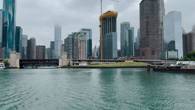 Majestic views of iconic Chicago, Illinois urban architecture and Lake Shore Drive as viewed from the Chicago River and Lake Michigan. A crane works on new building construction. - Powered by Shutterstock - Get 15% off with code: PIKWIZARD15
