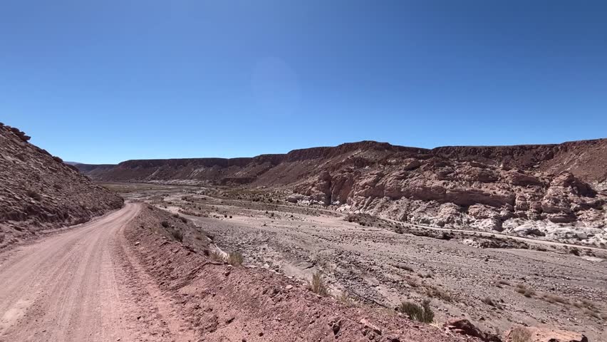Video footage driving a dirt road in spectacular landscape scenery close to  "Valle de Arcoiris"  Englisch "Rainbow Valley