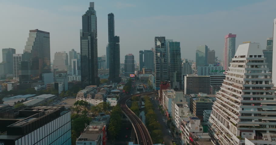 Aerial view city office building with BTS train metropolitan mass transport modern skyline of Bangkok Thailand