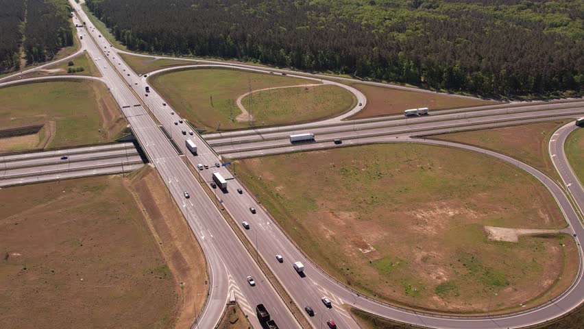 Aerial View of Highway Interchange with Traffic Flow Through Forest