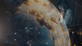 Businessman tapping tablet in office, activating rotating globe expanding tech data nodes. Holography, connectivity, innovation, technology, digitalization, futuristic, data visualization - Powered by Shutterstock - Get 15% off with code: PIKWIZARD15