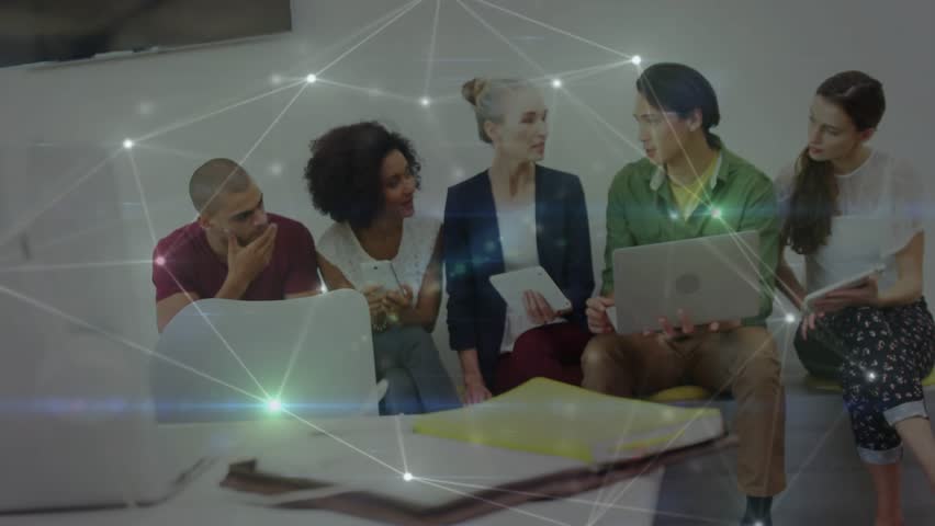 Colleague powering laptop and presenting while team pointing at glowing nodes dimming for business. Collaboration, teamwork, innovation, brainstorming, digital, corporate, discussion - Powered by Shutterstock - Get 15% off with code: PIKWIZARD15