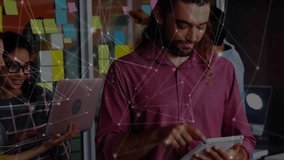 Man using tablet and launching network overlay while business team refining sticky-note ideas. Collaboration, teamwork, digital, innovation, brainstorming, modern, connectivity - Powered by Shutterstock - Get 15% off with code: PIKWIZARD15