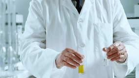 Senior scientist securing goggles and comparing test tubes with animated charts in chemistry lab. Researcher, experimentation, data analysis, innovation, scientific method, laboratory equipment, - Powered by Shutterstock - Get 15% off with code: PIKWIZARD15