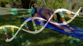 Kneeling on blue mat starting yoga, woman sliding through child's pose into plank in sunlit park. Wellness, fitness, outdoor, serenity, stretching, exercise, nature - Powered by Shutterstock - Get 15% off with code: PIKWIZARD15