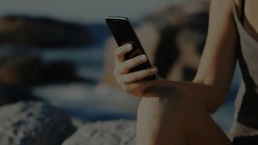 Woman tapping smartphone initiating neon scanning bar clearing code and revealing shore tech demo. Technology, digital, futuristic, innovation, cybersecurity, mobile, nature - Powered by Shutterstock - Get 15% off with code: PIKWIZARD15