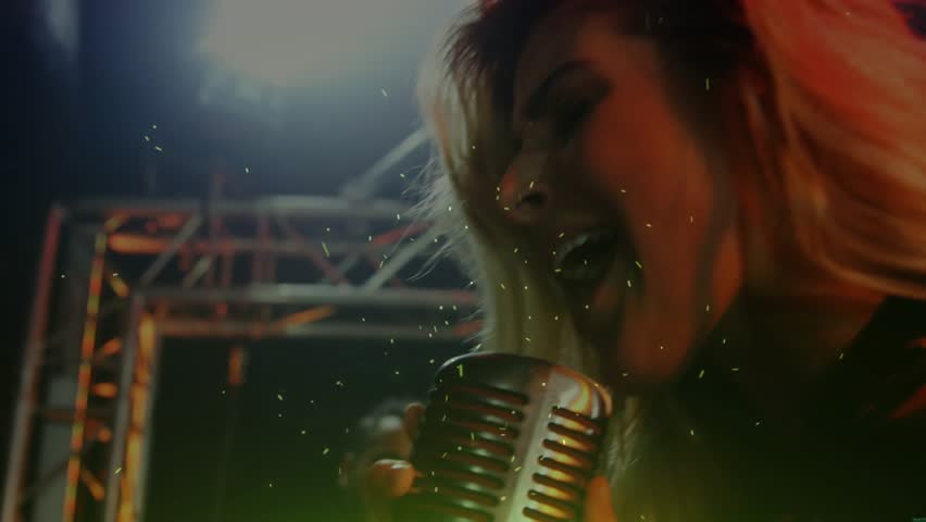 Belting notes on mic while guitarist strumming at music show, activating colored lights across haze. Performance, concert, music, stage, entertainment, vocalist, musician