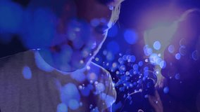 Man and woman stepping on stage, leaning toward microphone, singing duet under blue bokeh lights. Performance, duet, vocalists, stage, illumination, atmosphere, connectivity - Powered by Shutterstock - Get 15% off with code: PIKWIZARD15