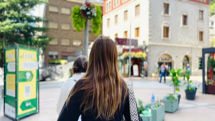 Young Woman Walking Through Andorra City Center – Urban Travel Lifestyle.