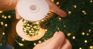 Decorating Christmas Tree with String Lights for Festive Holiday Ambiance - Powered by Shutterstock - Get 15% off with code: PIKWIZARD15