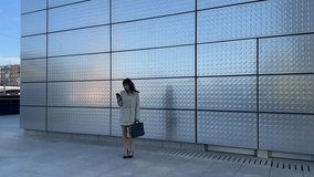 Businesswoman walking and using smartphone in the city - Powered by Shutterstock - Get 15% off with code: PIKWIZARD15