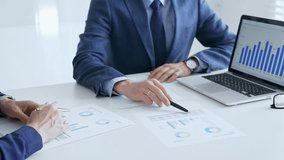 Business team of several colleagues discussing financial data on a laptop while analyzing charts and market trends in office. Businesspeople and finance concept - Powered by Shutterstock - Get 15% off with code: PIKWIZARD15