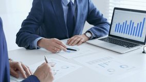 Business team of several colleagues discussing financial data on a laptop while analyzing charts and market trends in office. Businesspeople and finance concept - Powered by Shutterstock - Get 15% off with code: PIKWIZARD15