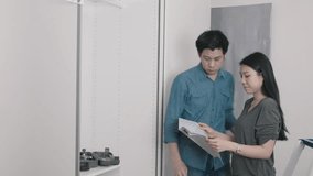 A couple collaborates on their home renovation project, discussing plans and ideas. The image captures a moment of teamwork and communication in a modern setting. - Powered by Shutterstock - Get 15% off with code: PIKWIZARD15