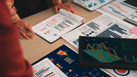 A diverse team collaborates and analyzes various charts and graphs in a modern office workspace, aiming for effective business strategies and informed decision making. SACTR - Powered by Shutterstock - Get 15% off with code: PIKWIZARD15