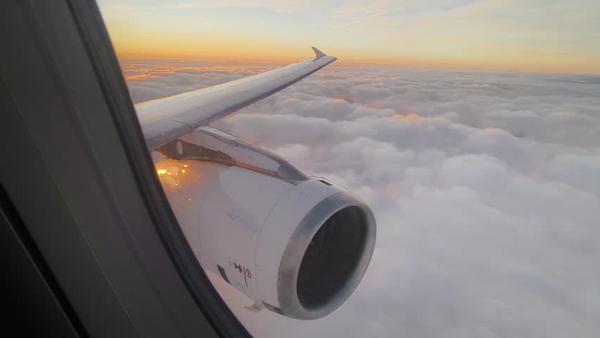 View from the airplane window of a wing with an engine during flight