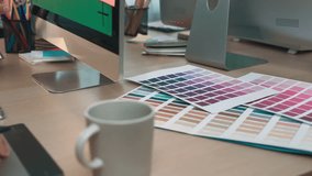 A modern workspace showcasing a vibrant aesthetic with color swatches, a computer, a smartphone, and a coffee cup, embodying creativity and design inspiration. SACTR - Powered by Shutterstock - Get 15% off with code: PIKWIZARD15