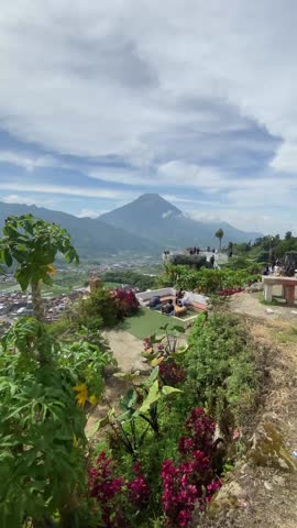 View of a flower garden, several people relaxing against the backdrop of the sky and Mount Sindoro.
Location: Wonosobo, Central Java, Indonesia.
Video taken on October 1, 2025.