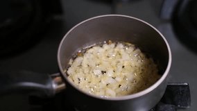 Slow motion egg cracking into frying pan with onions. Raw egg dropping into pan with caramelized onions in slow motion. Cooking egg and onions in skillet slow motion. - Powered by Shutterstock - Get 15% off with code: PIKWIZARD15