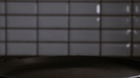 Raw egg falling in nonstick frying pan in slow motion. Slow motion egg dropping into pan. Cooking egg in nonstick pan slow motion. - Powered by Shutterstock - Get 15% off with code: PIKWIZARD15