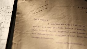 A person wearing blue protective gloves carefully turns pages of an ancient document, revealing old text. This archival work highlights historical preservation, meticulous research - Powered by Shutterstock - Get 15% off with code: PIKWIZARD15