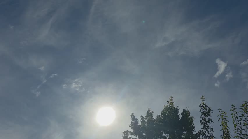 Bright sky with sun and light clouds over trees, the sky over Wüsting, 27798 Hude, Germany