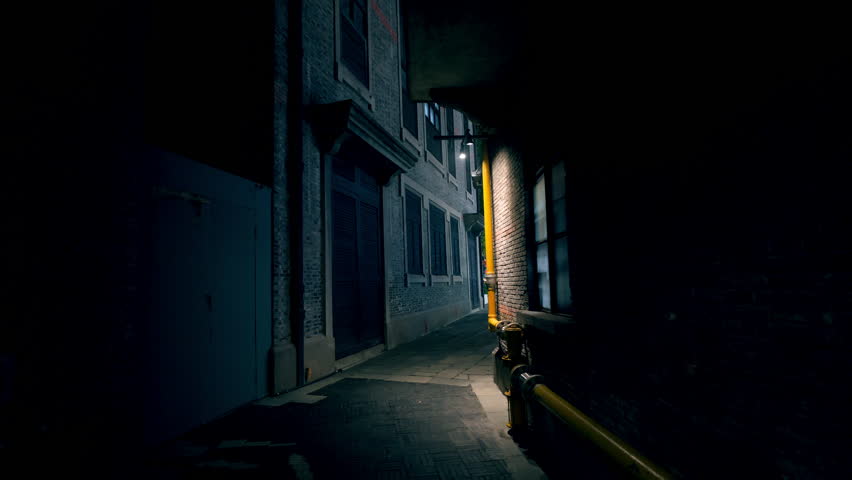 dark alley at night with glowing windows of buildings