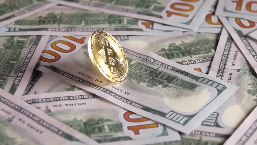 "Close-up slow-motion of a spinning Bitcoin on a stack of hundred-dollar bills, symbolizing cryptocurrency, finance, and digital wealth."