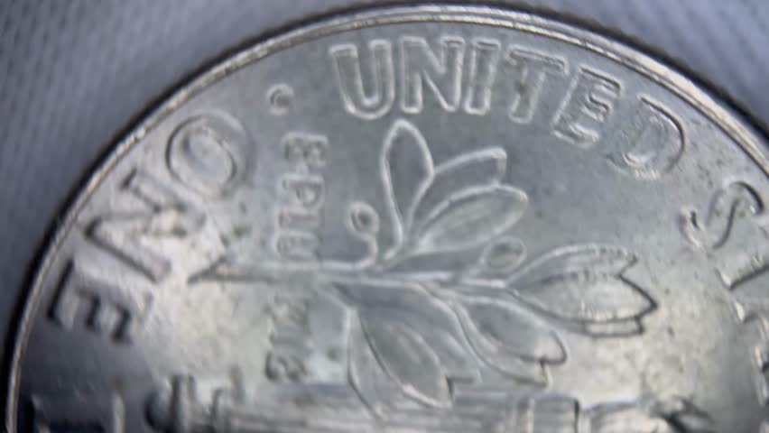 Macro close-up of stacked US coins, quarter dollar, one cent, one dime. Financial concept, perfect for banking, investment or wealth management visuals.