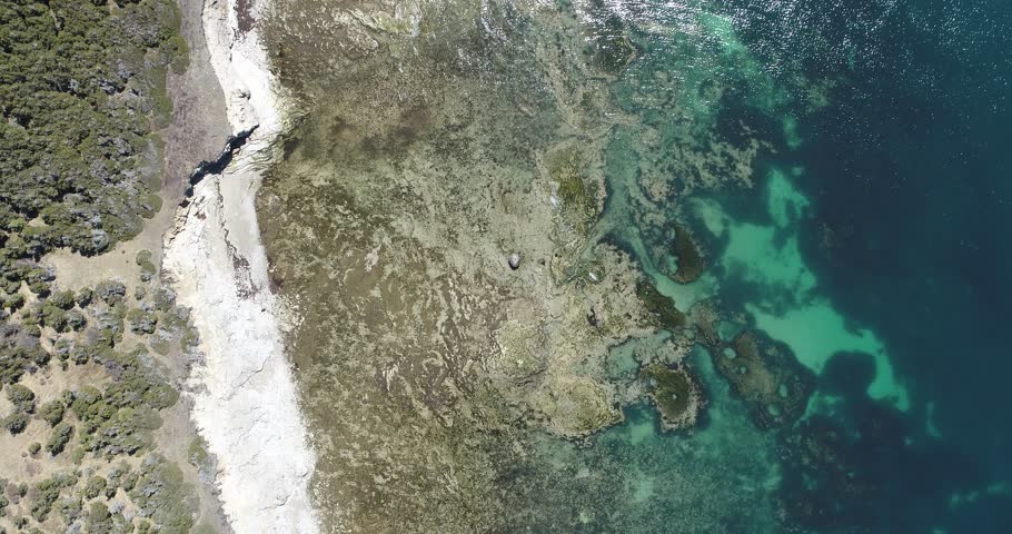 Pointe des Morts on Anticosti Island Reveals a Stunning Coastline with Rocky Shores, Clear Waters, and Forest Edges, Creating a Breathtaking View of Nature and the Gulf of St. Lawrence