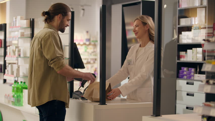 Pharmacist woman sell medicine in pharmacy cashier counter help customers buying medication health care service medical prescription drugstore order using contactless payment buy pills drugs vitamins