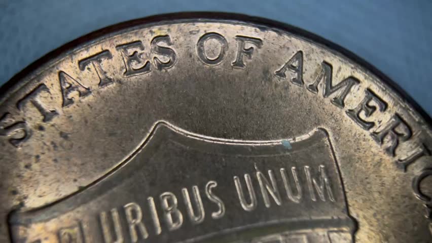 Macro close-up of stacked US coins, quarter dollar, one cent, one dime. Financial concept, perfect for banking, investment or wealth management visuals.