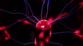 A plasma ball with a blue energy beam and a red discharge. A magical image of moving energy. A close-up of the core of the plasma ball. - Powered by Shutterstock - Get 15% off with code: PIKWIZARD15